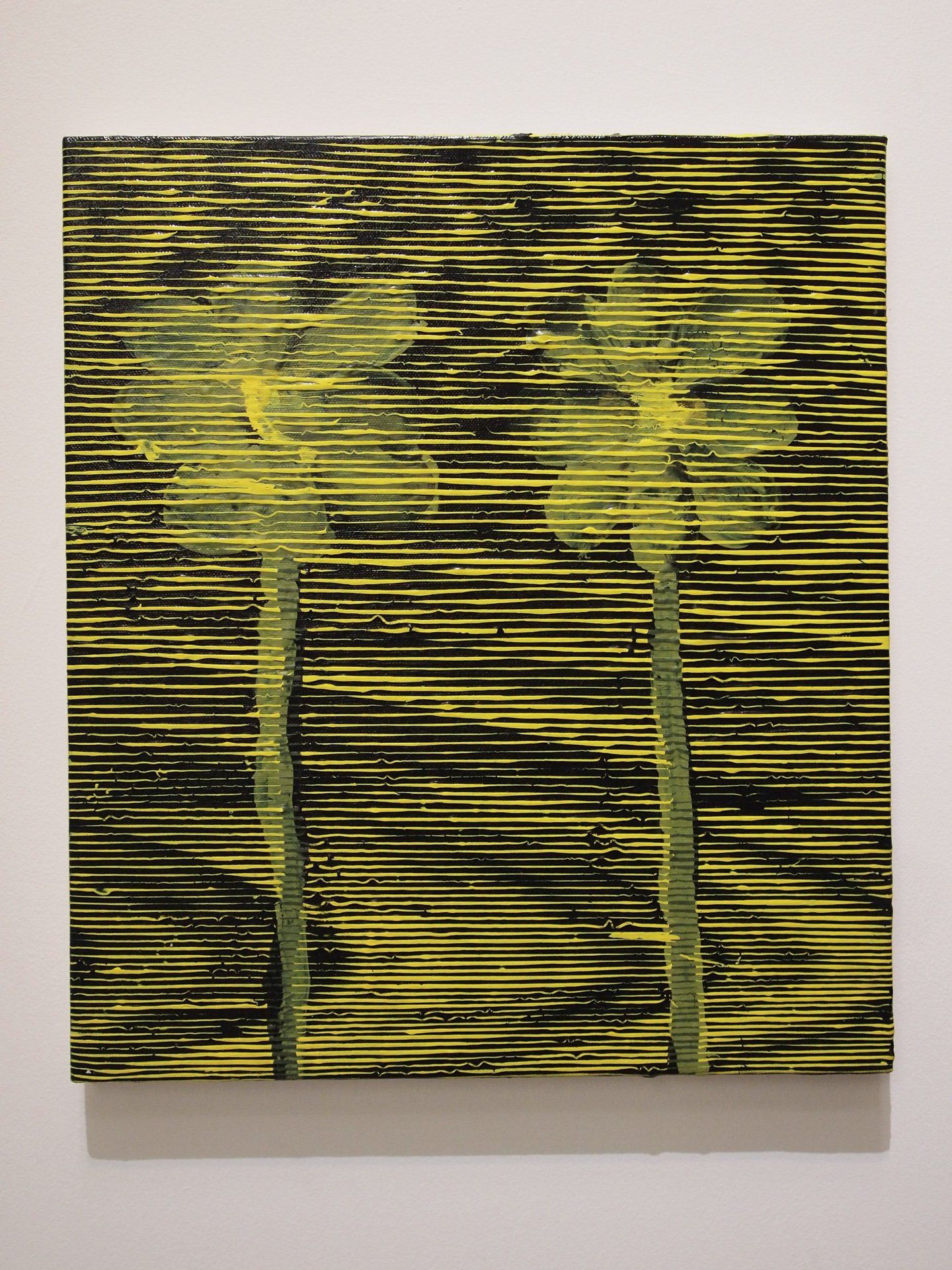 A painting of palm trees is hanging on a wall.