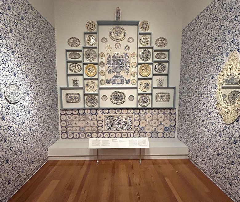 A double exposed photograph of a mushroom cloud from a bomb exploding in a city and rolling green mountains.