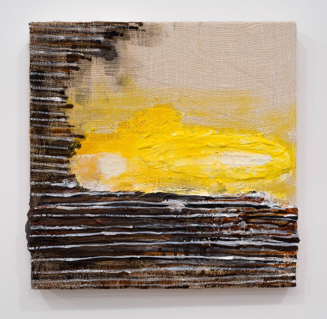 A yellow and black painting on a white wall.