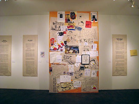 A wall with many papers on it