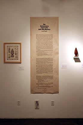 A white wall with a large piece of paper hanging on it