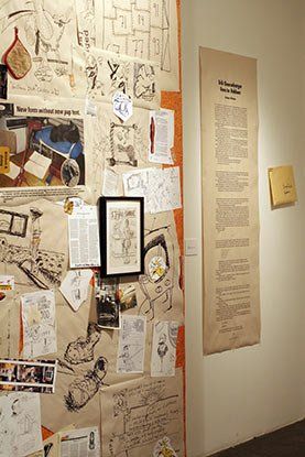 A wall with a lot of pictures and drawings on it.