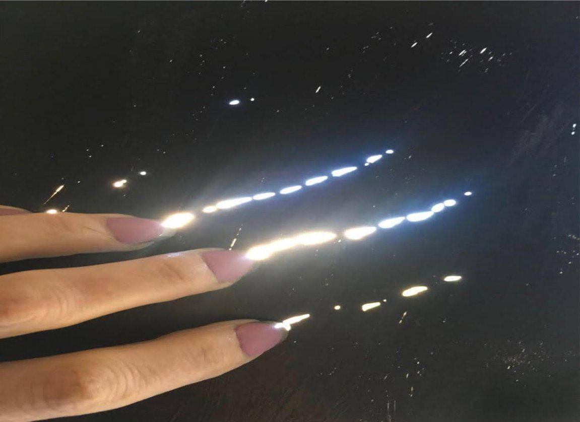 A close up of a woman 's nails on a black surface
