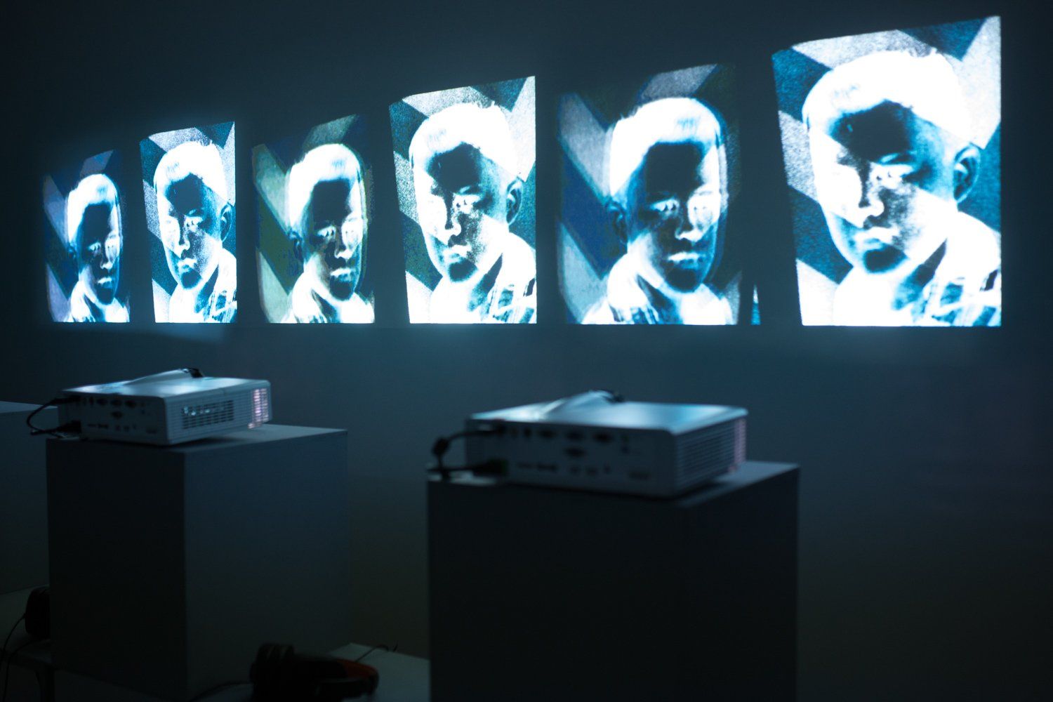 A projector is displaying a series of images on a wall