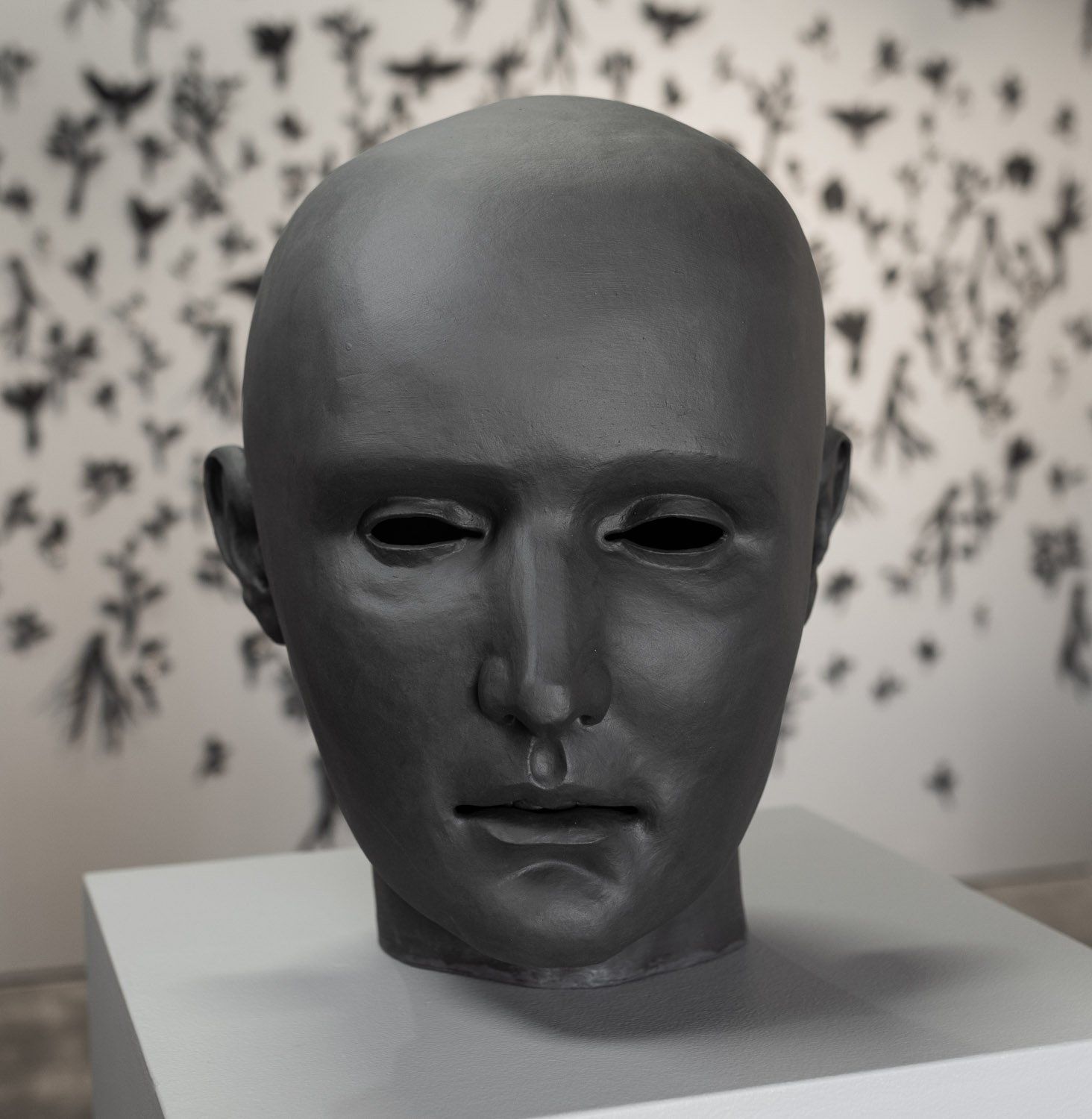 A statue of a man 's head with a tear coming out of his nose