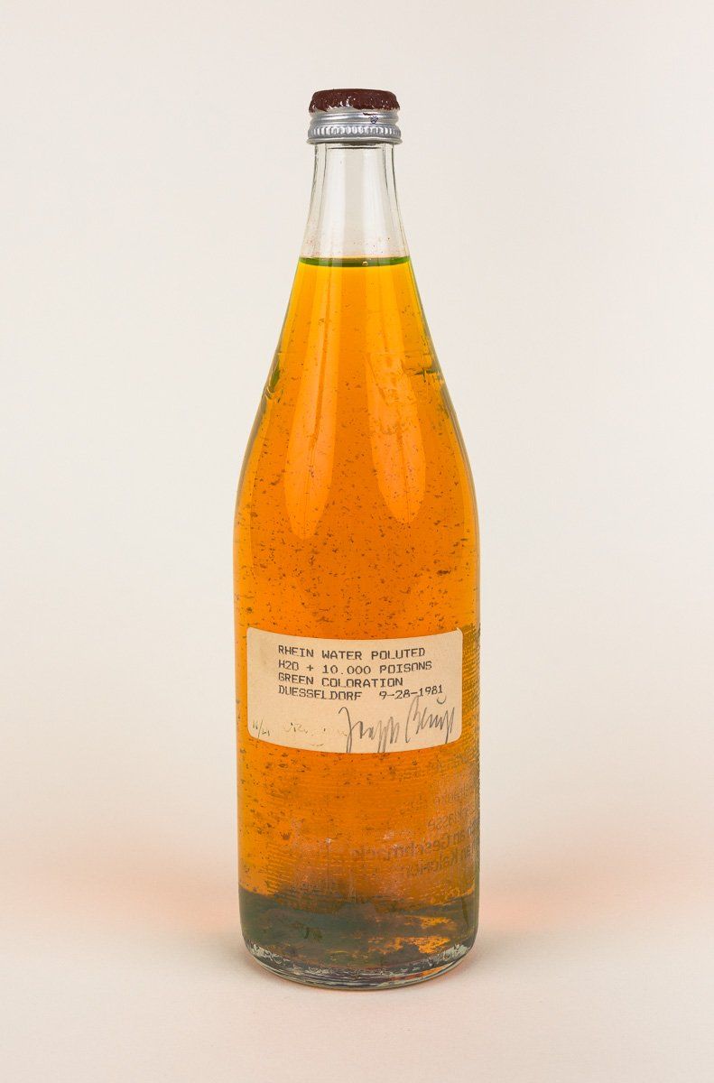 A bottle of orange liquid with a white label on it
