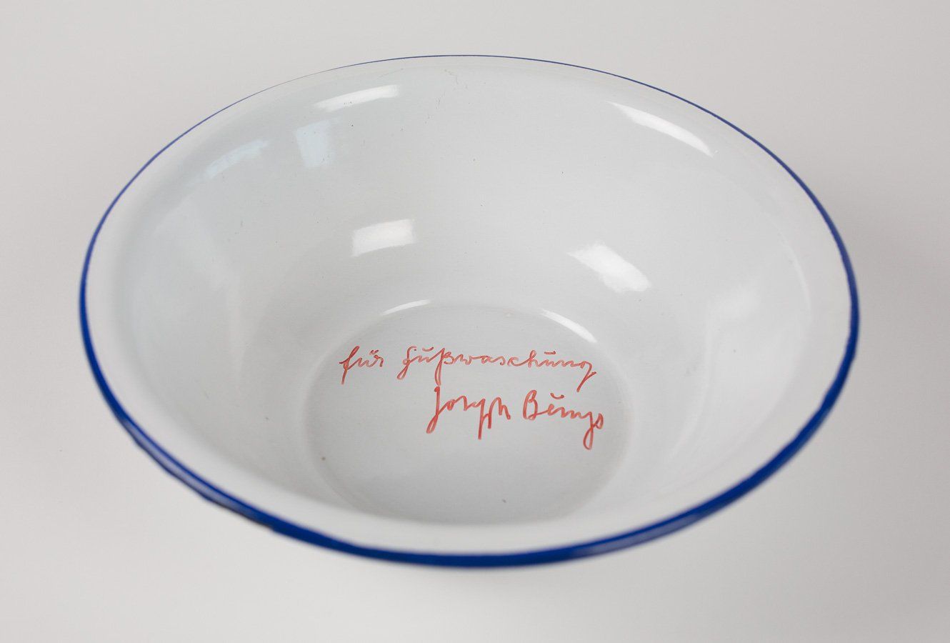 A white bowl with a blue rim has the words for supervision written on it