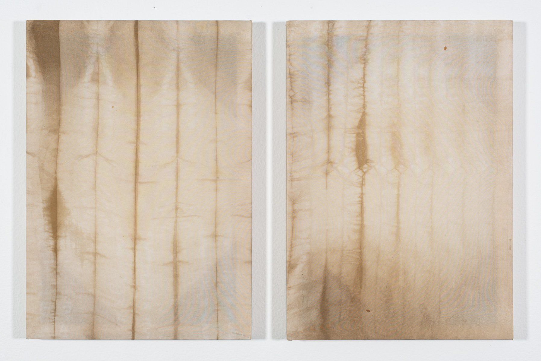 Two pieces of wood are sitting next to each other on a white surface.