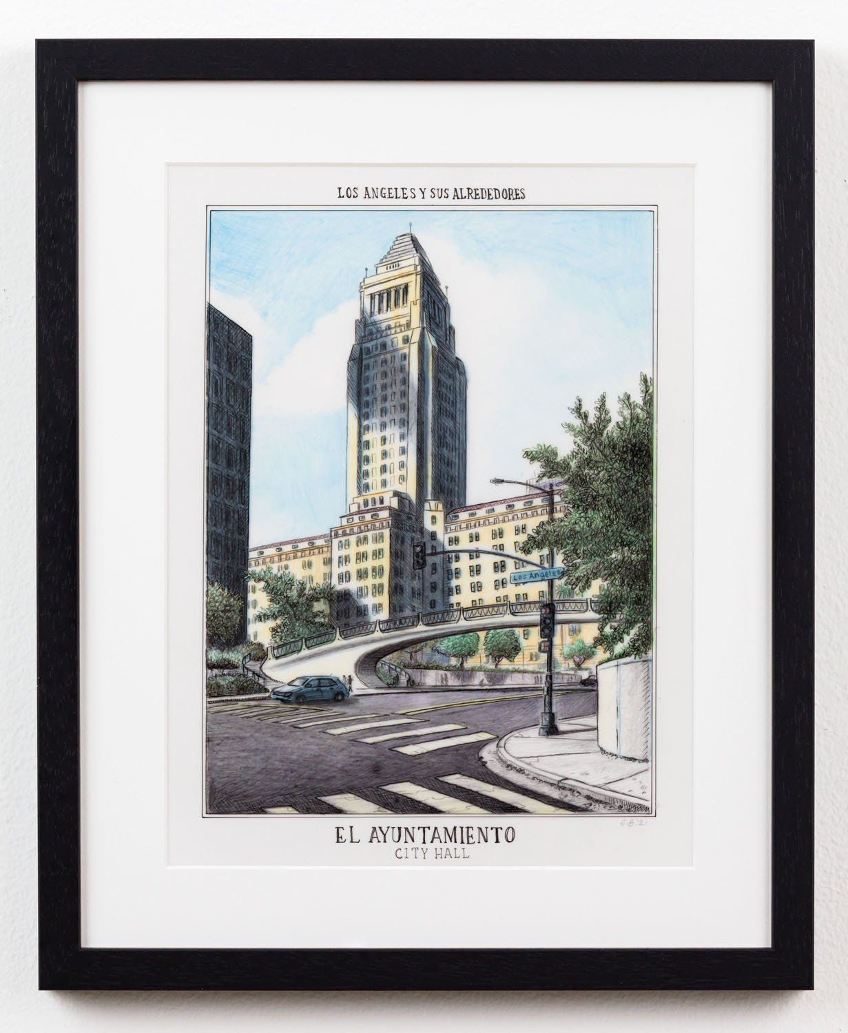 A framed picture of a city street with a tall building in the background