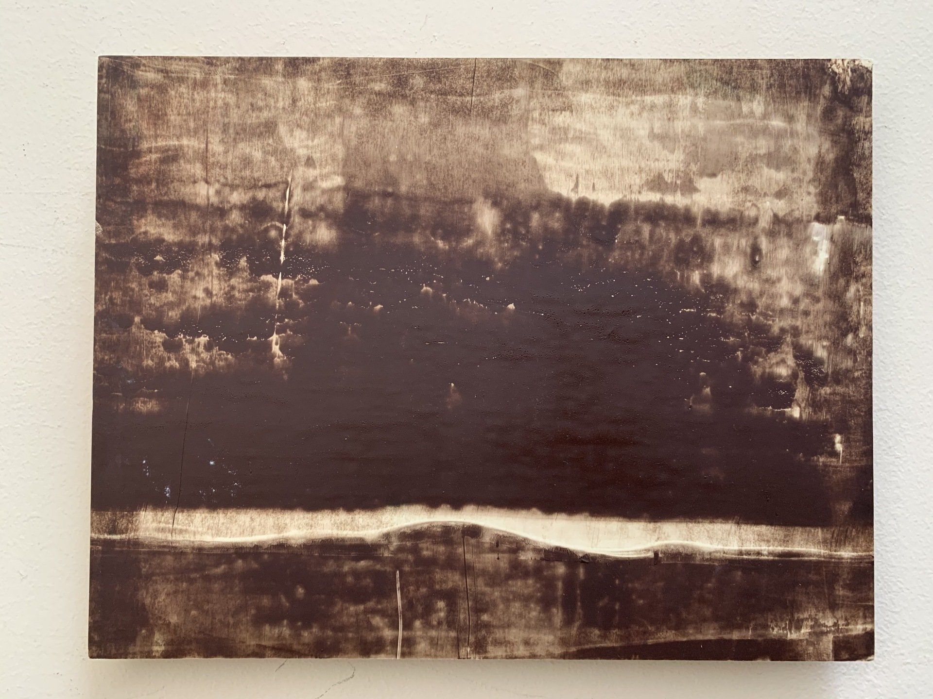 A black and white painting of a lake with trees in the background