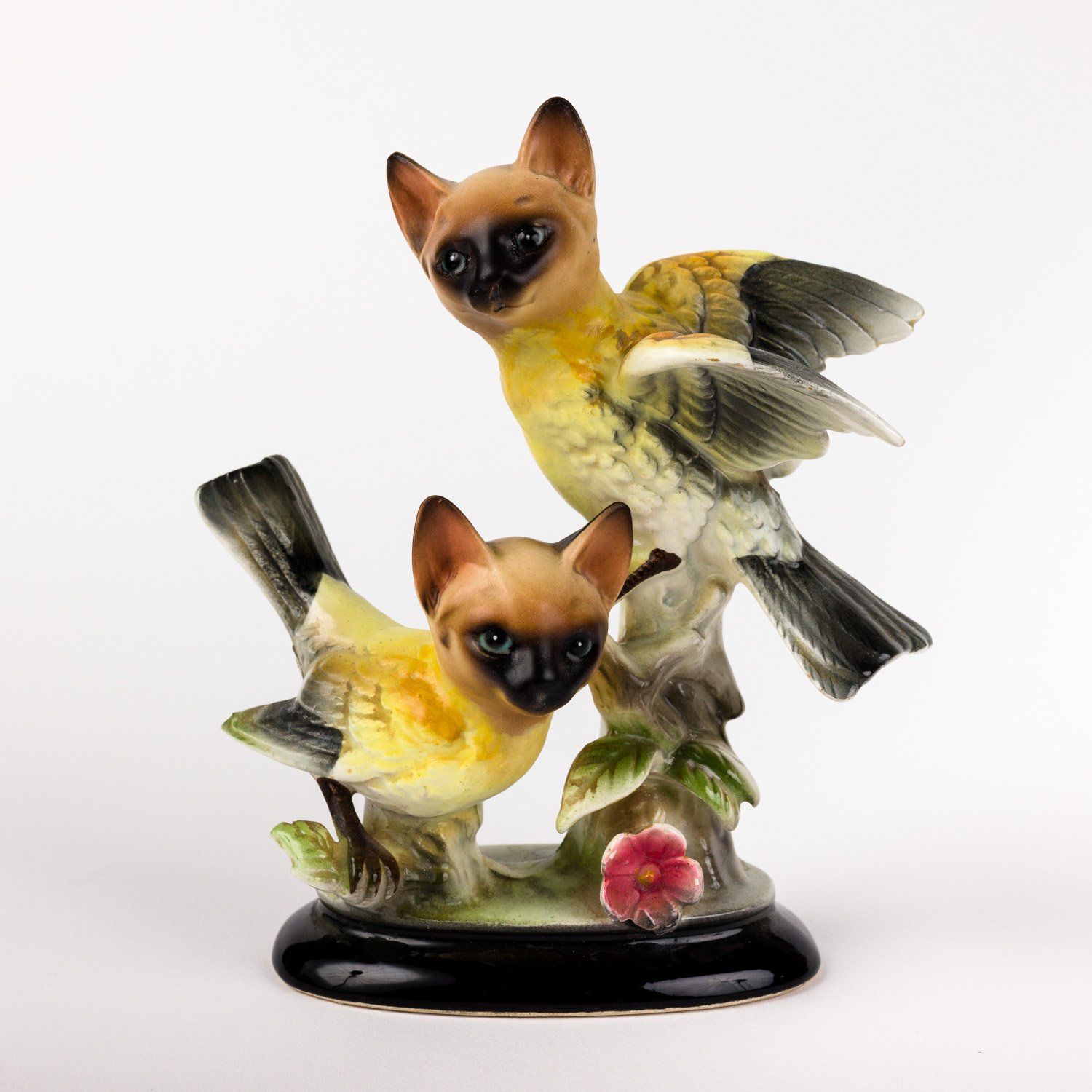 A statue of two birds sitting on a branch