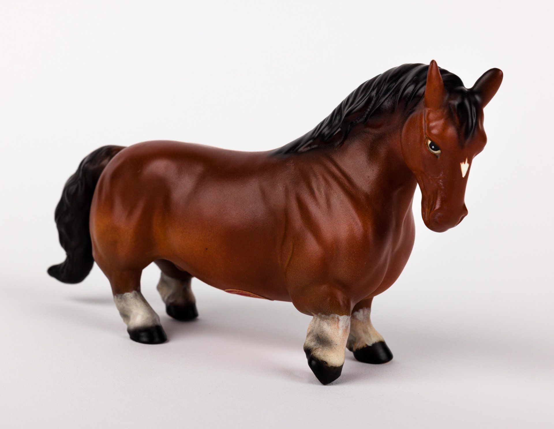 A brown toy horse with a black mane and tail