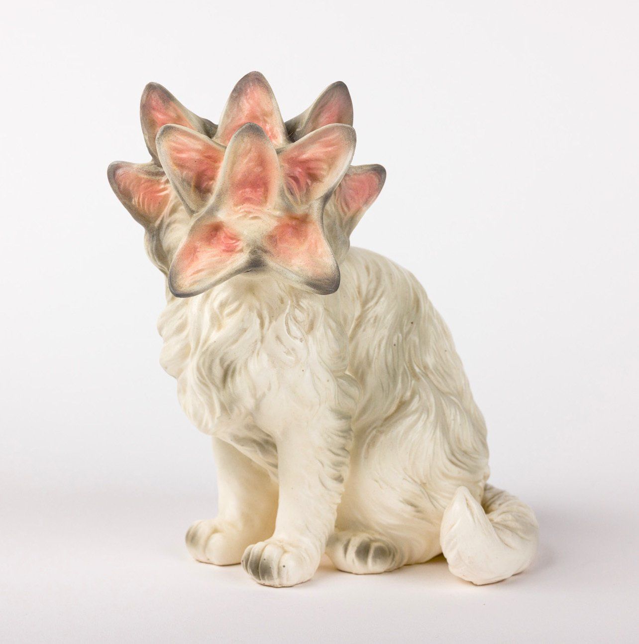 A statue of a dog with a flower on its head