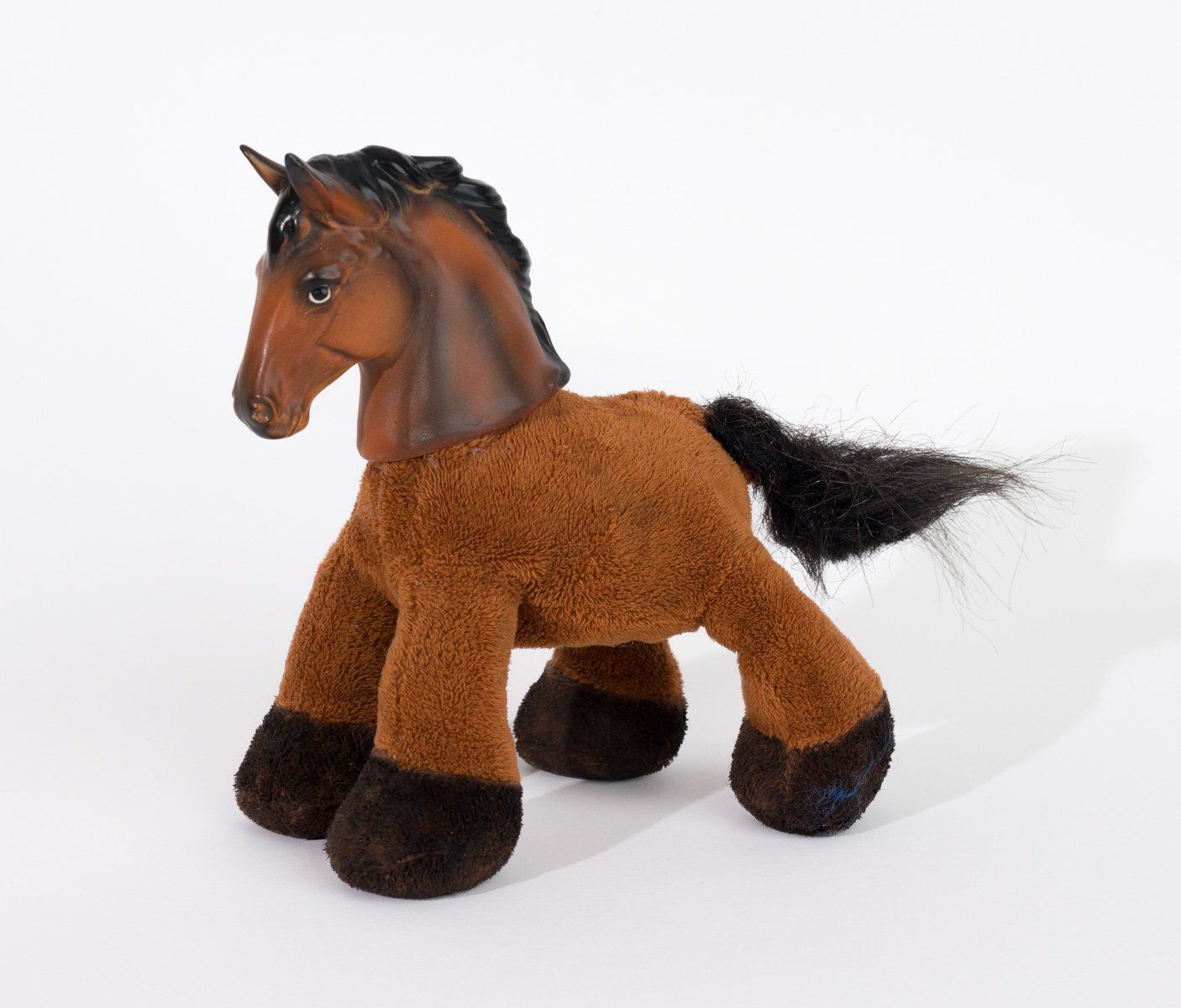 A brown stuffed horse with a black mane and tail