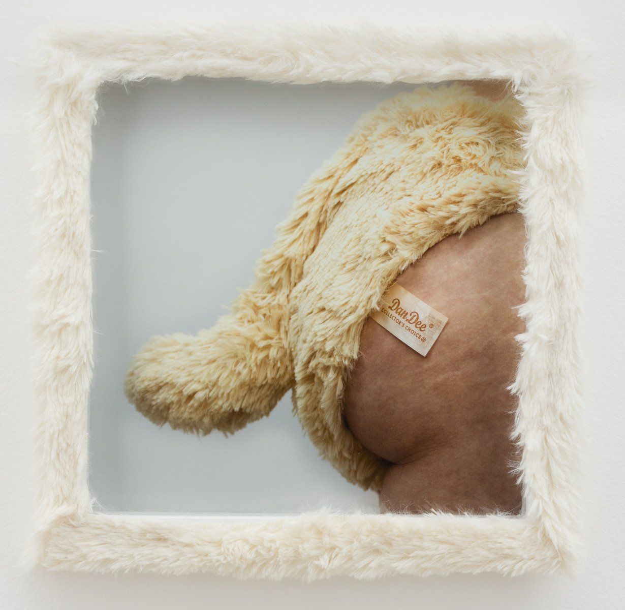 A picture of a stuffed animal with a tag that says barbie on it