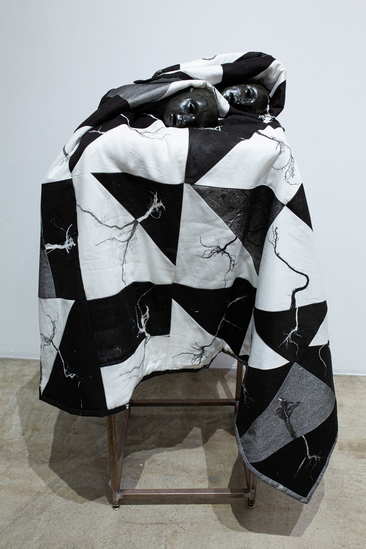 A black and white blanket is sitting on top of a chair.