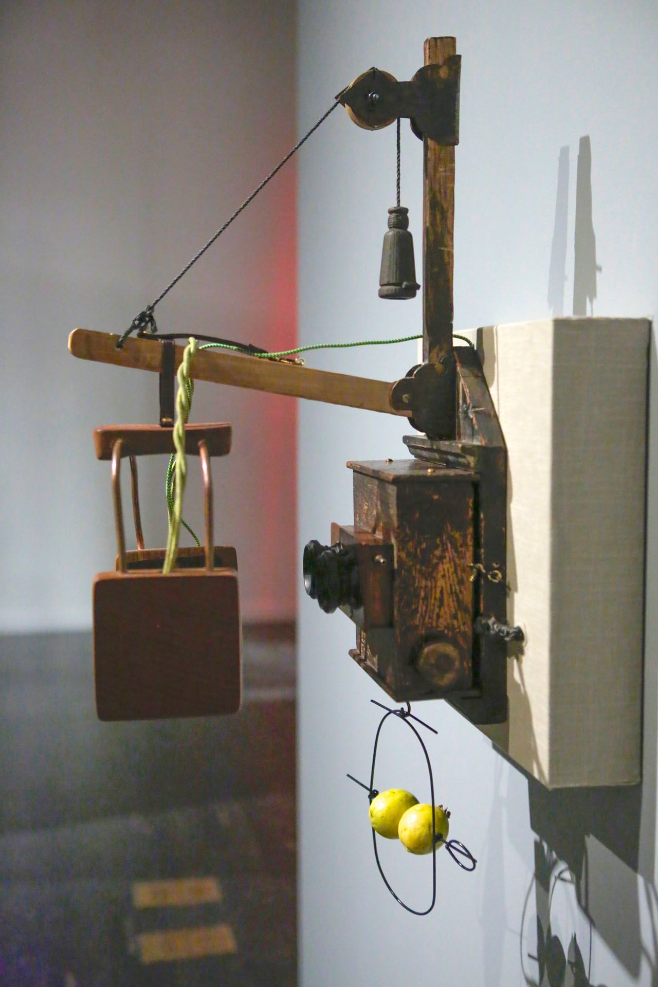 A sculpture of a crane with a chair attached to it
