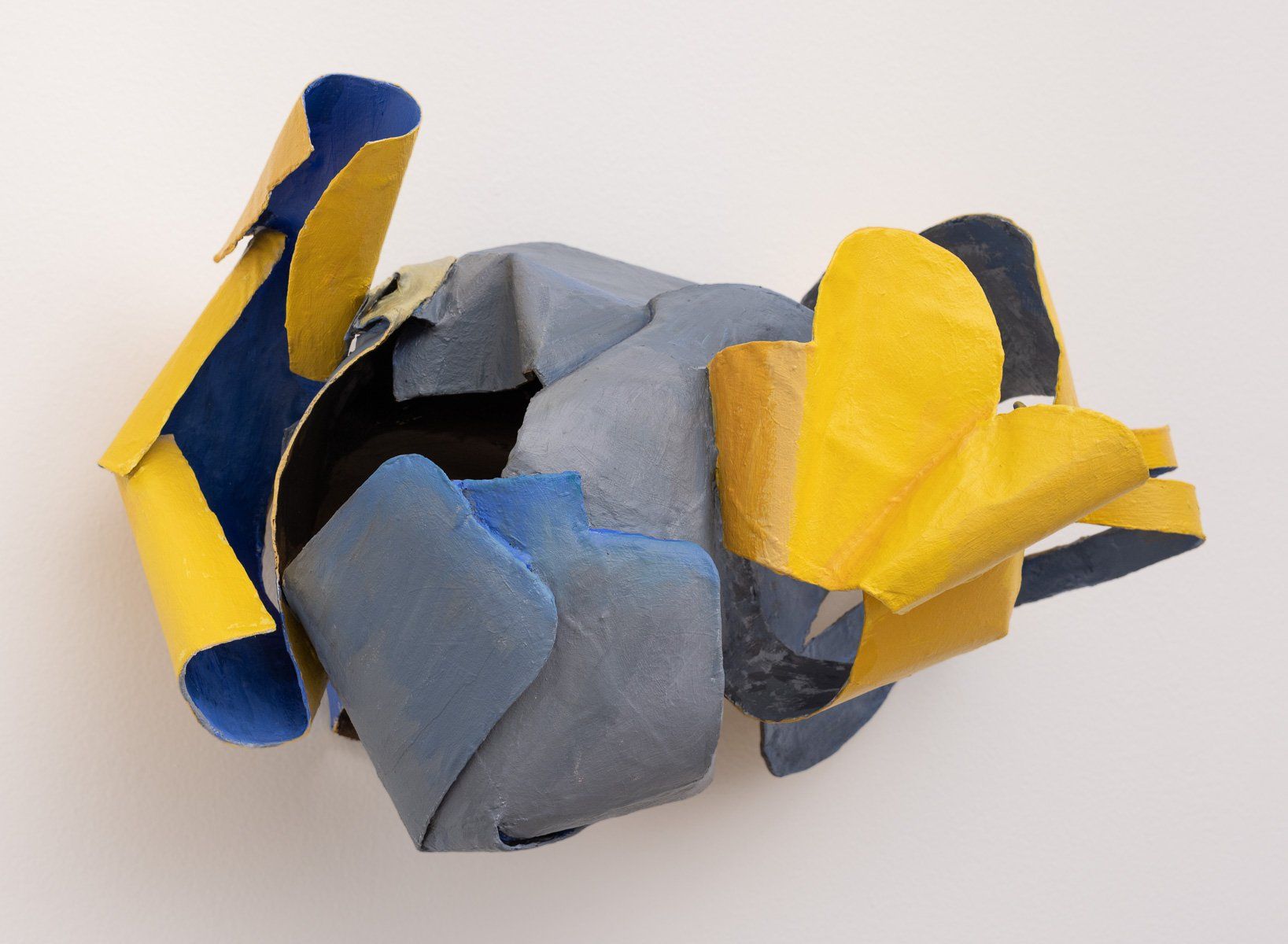 A piece of blue and yellow paper on a white surface