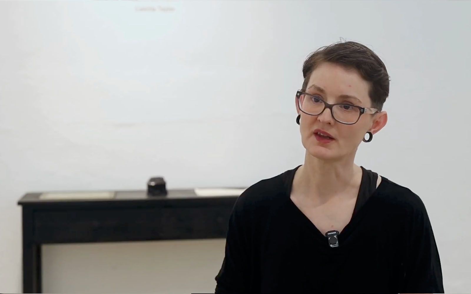 Camilla Taylor sitting for an interview inside of Track 16 Gallery.