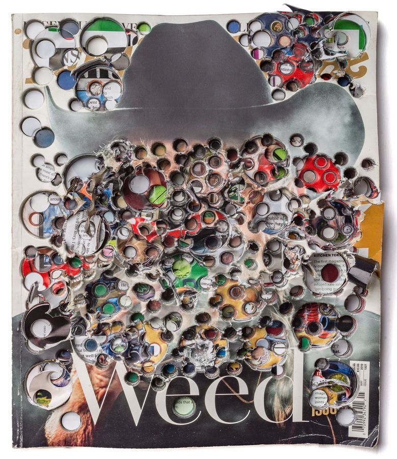 photograph of a man in a cowboy hat and the photograph has holes punched all through it.