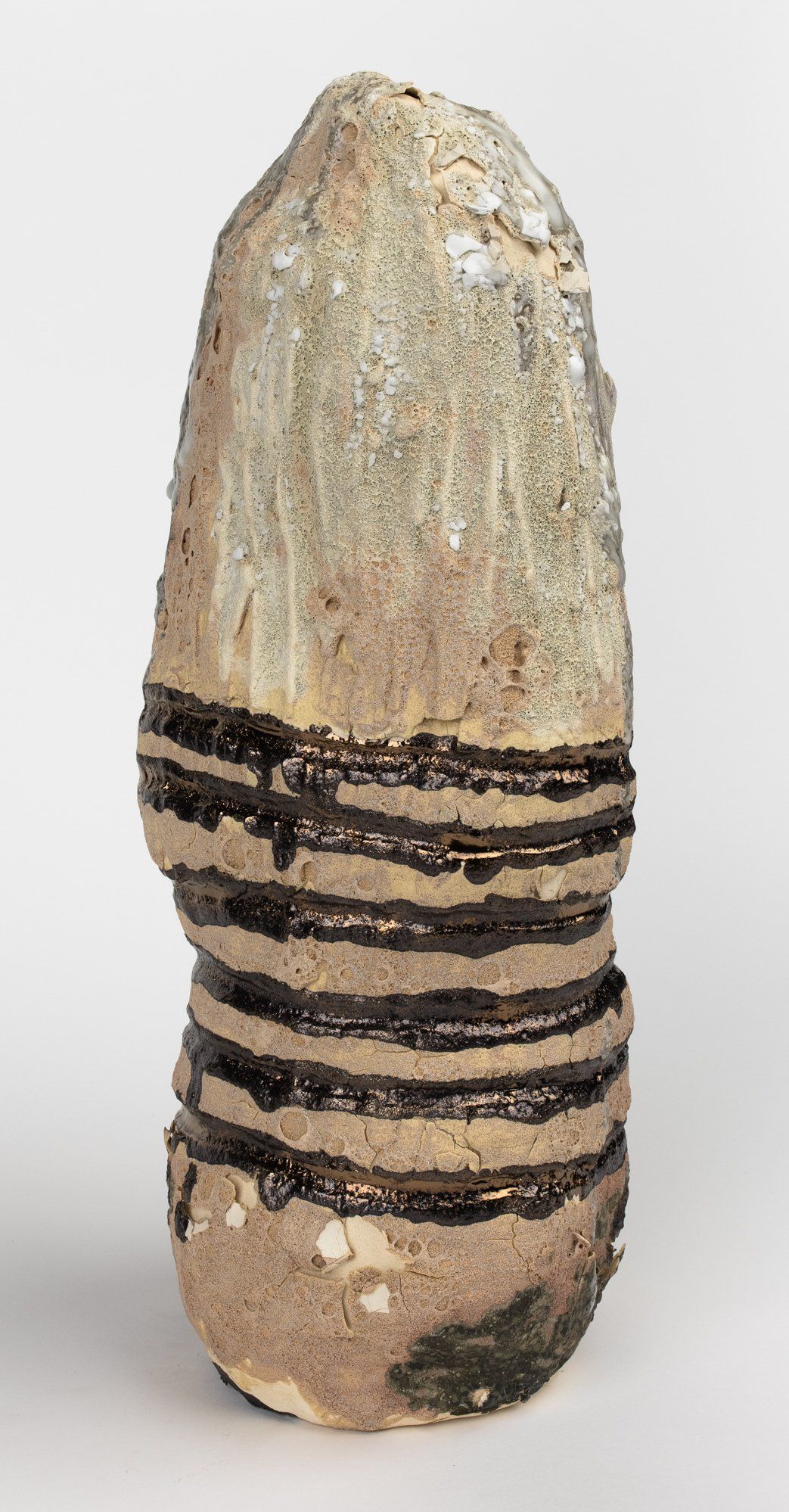 A close up of a ceramic sculpture on a white surface.