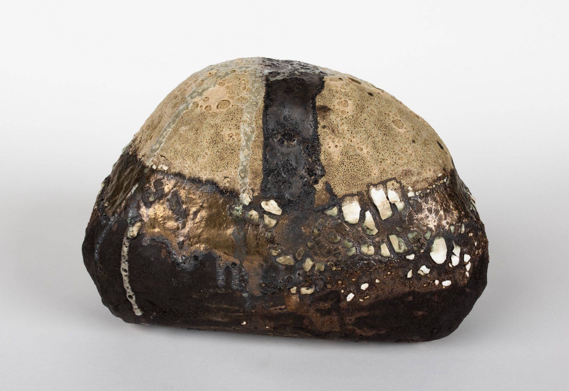 A large rock is sitting on a white surface.