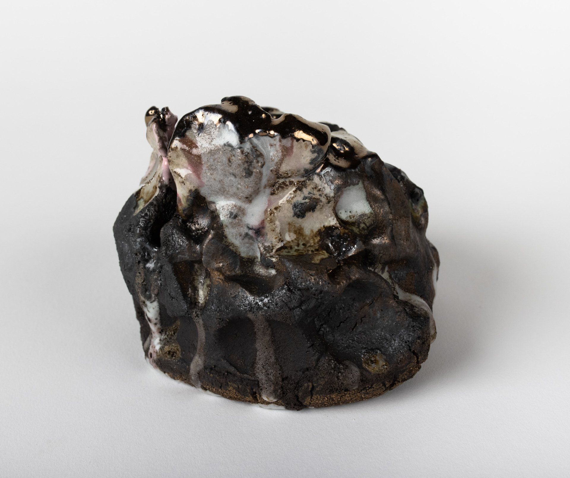 A small black and white sculpture on a white surface