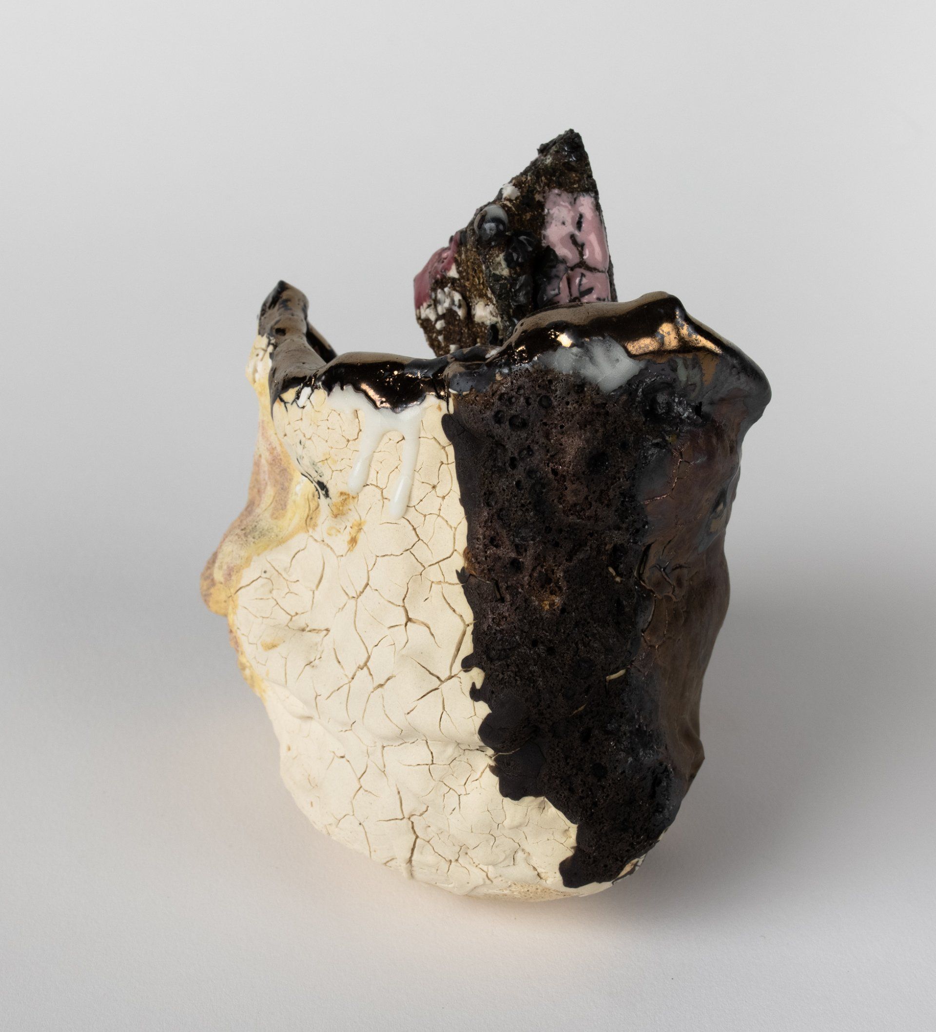 A black and white piece of rock is sitting on a white surface