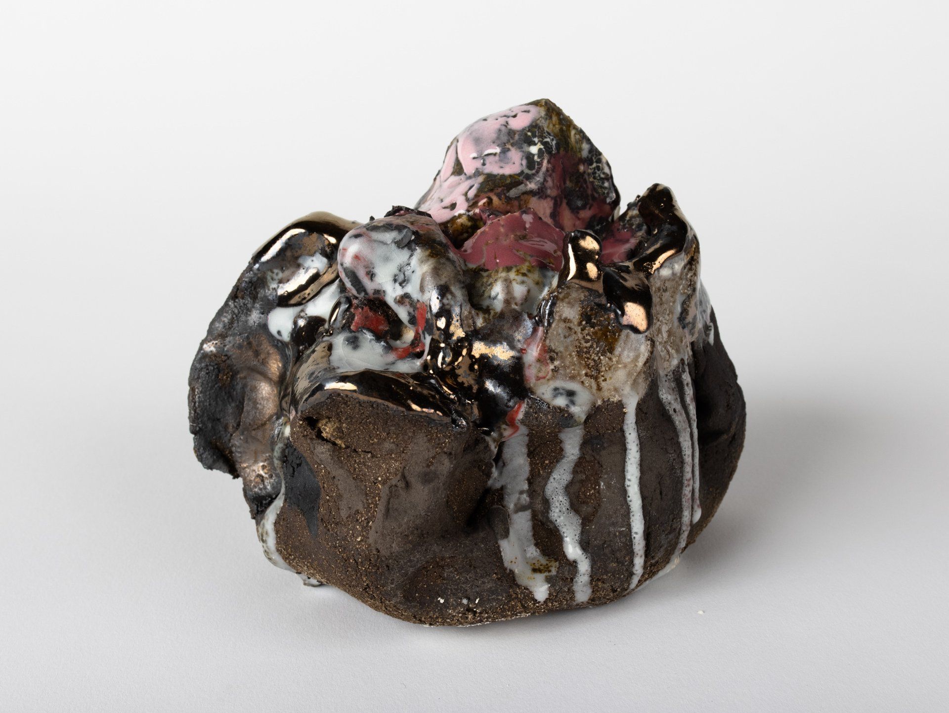 A close up of a ceramic sculpture on a white surface