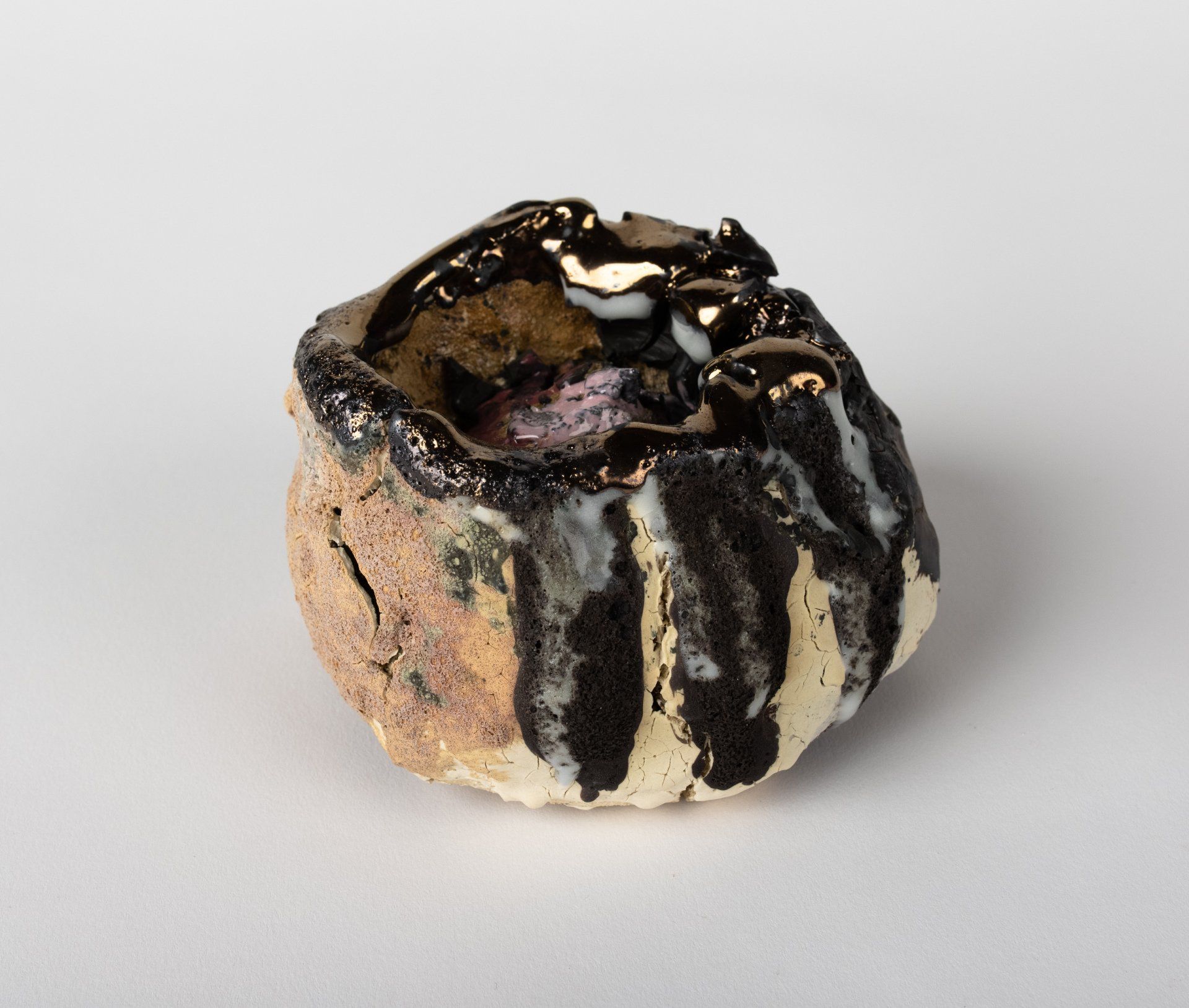 A black and white ceramic object is sitting on a white surface