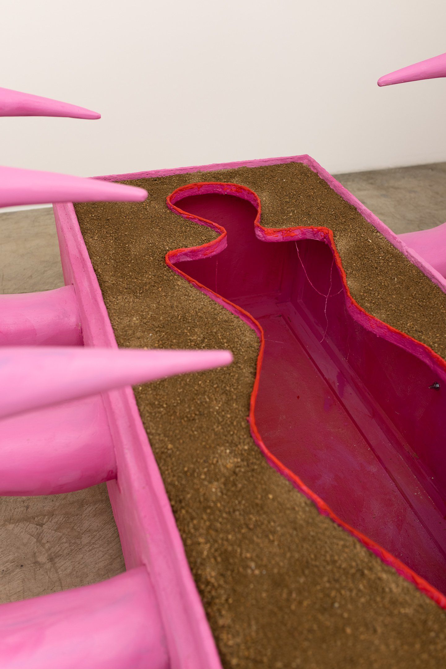 A close up of a pink sculpture with a hole in the middle.