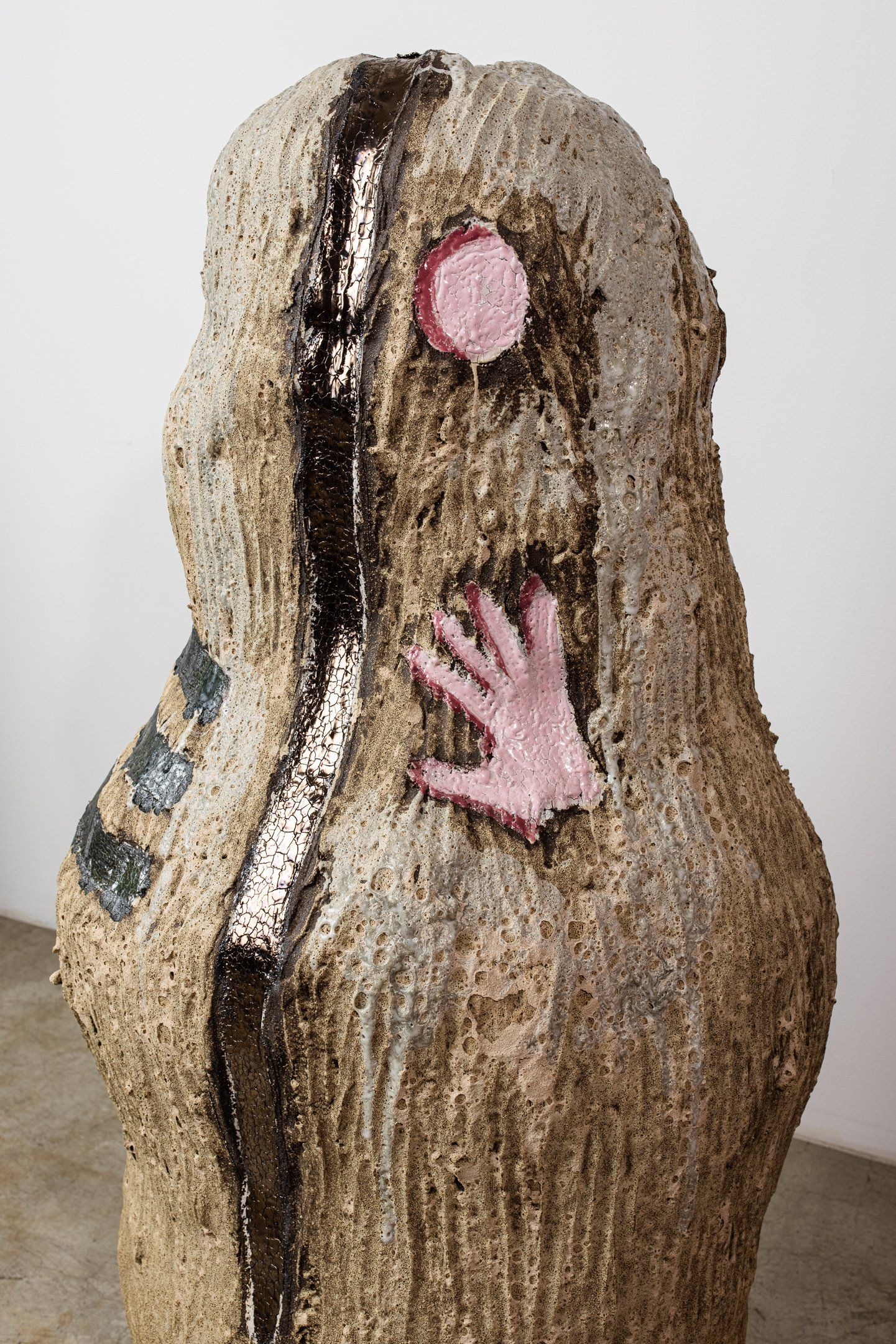 A statue with a hand sticking out of it 's mouth.