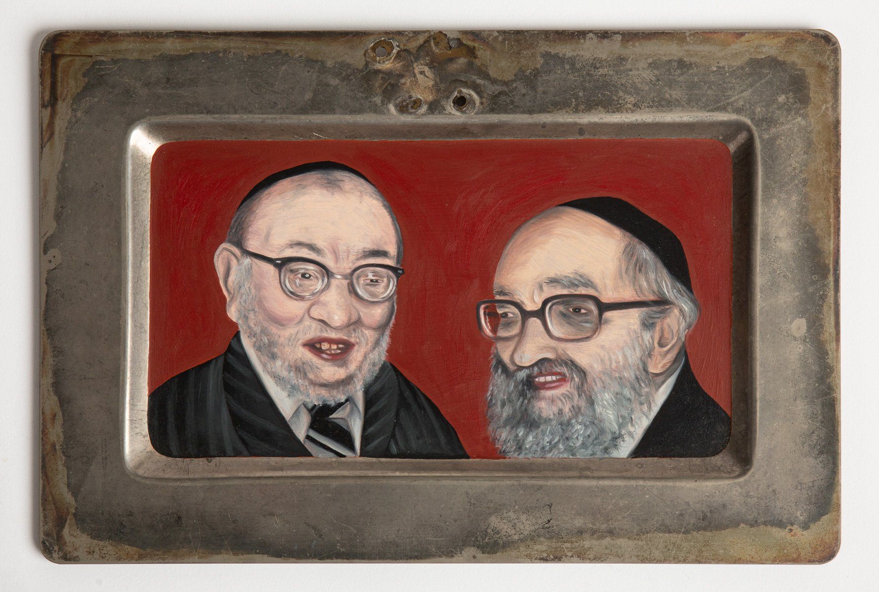 A picture of two men with glasses on a metal tray