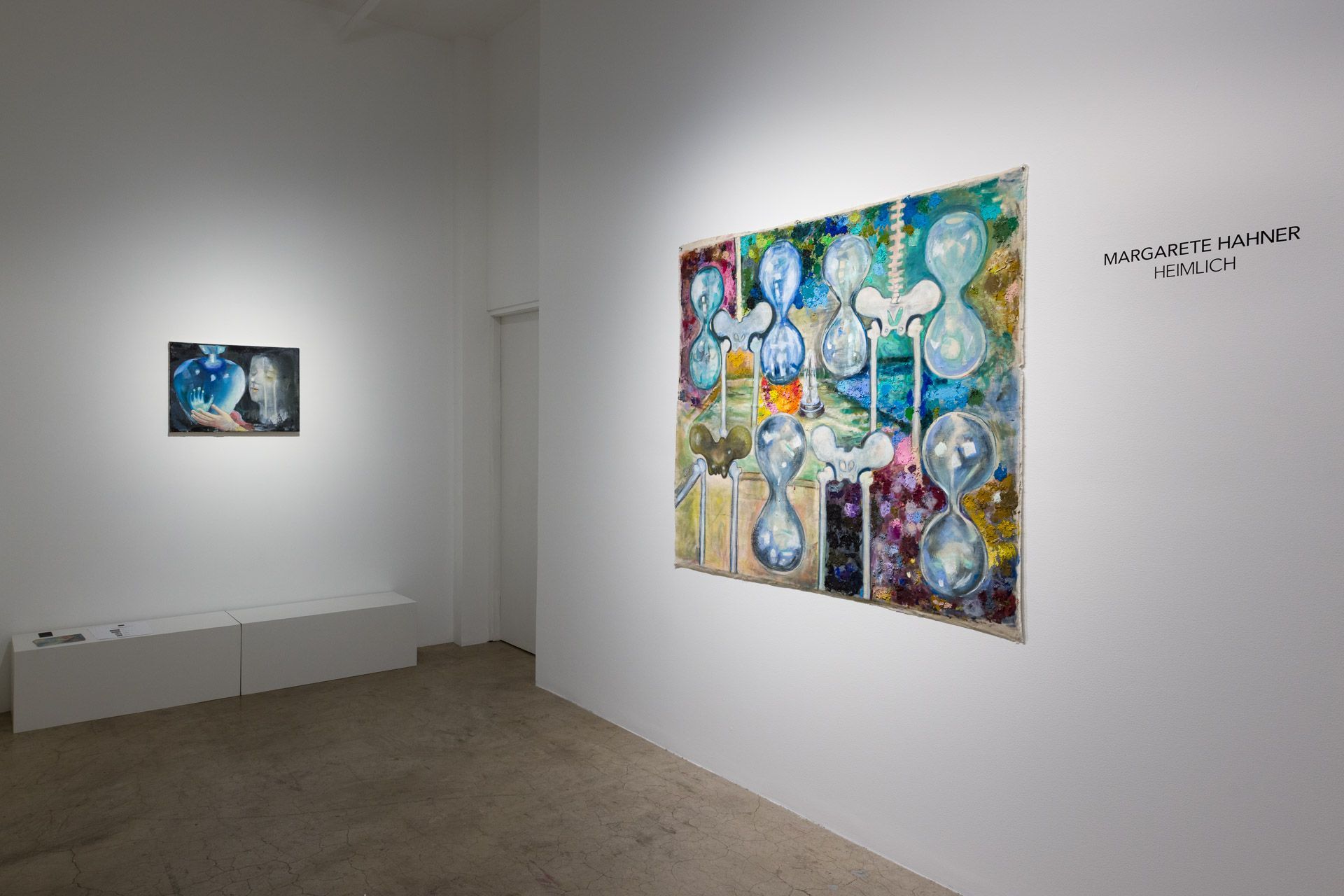 There are two paintings on the wall in this room.