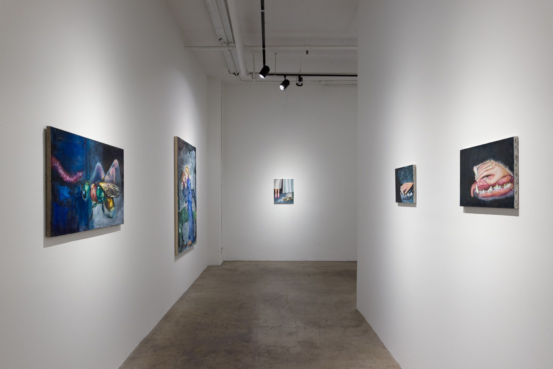 There are many paintings on the wall in this room.
