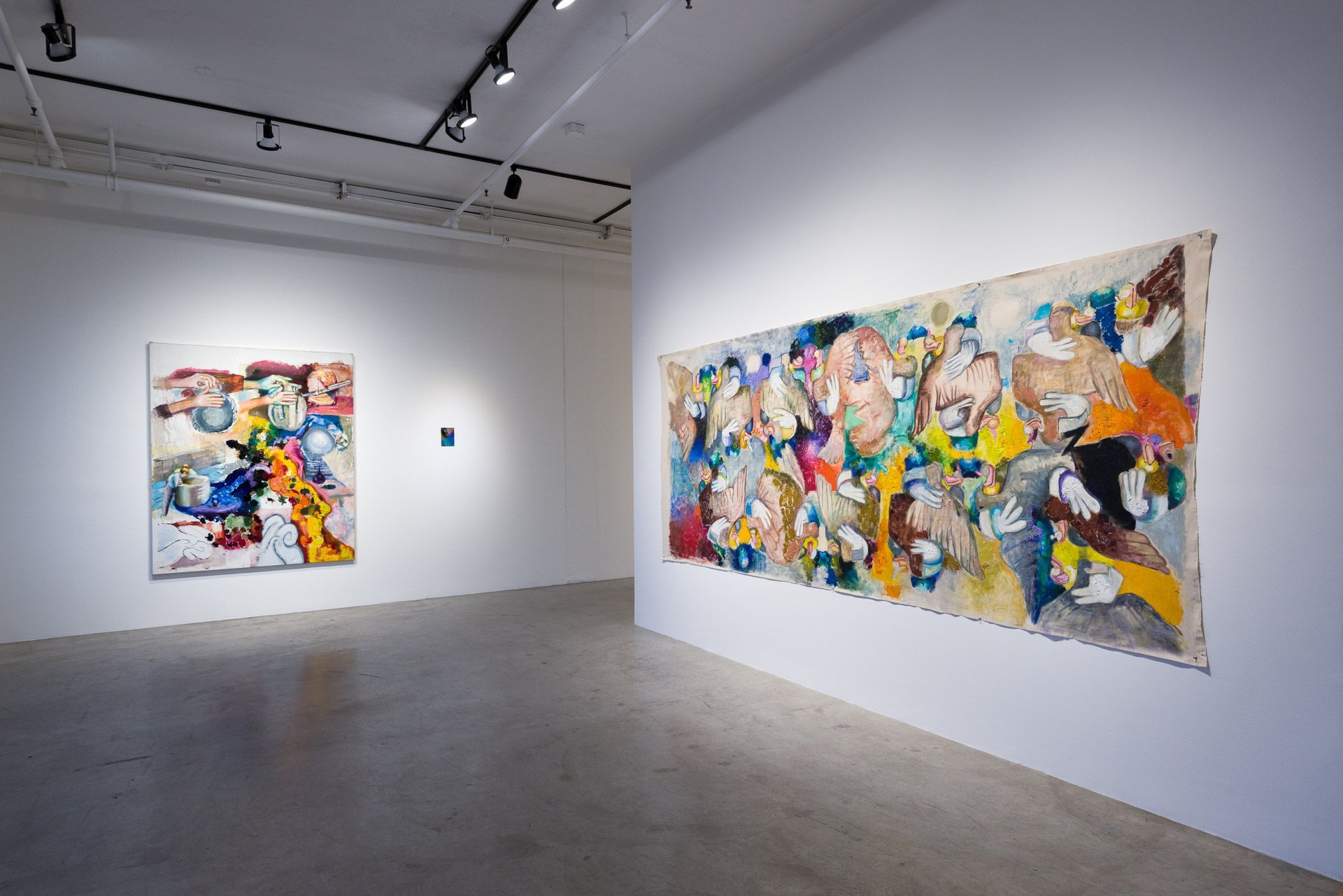 There are two paintings on the wall in a room.