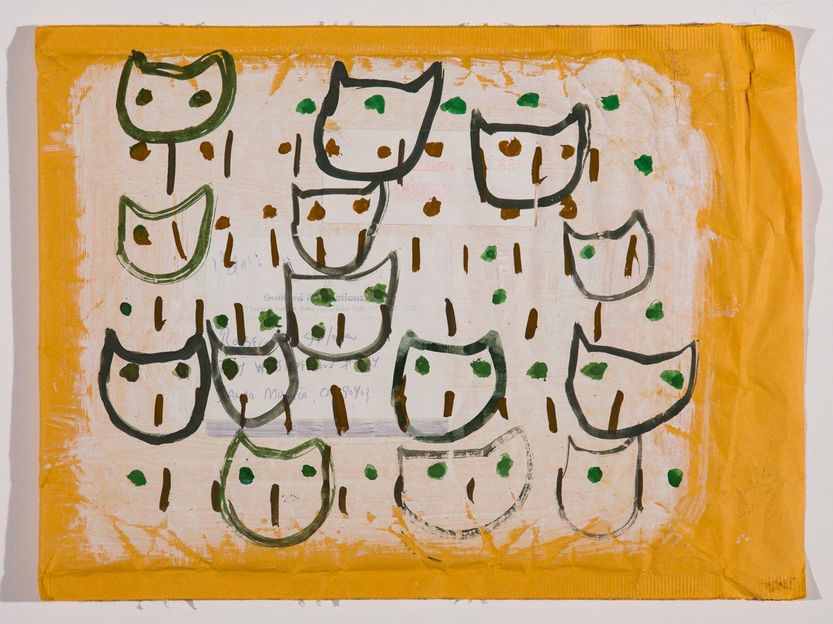 A yellow towel with a drawing of cats on it