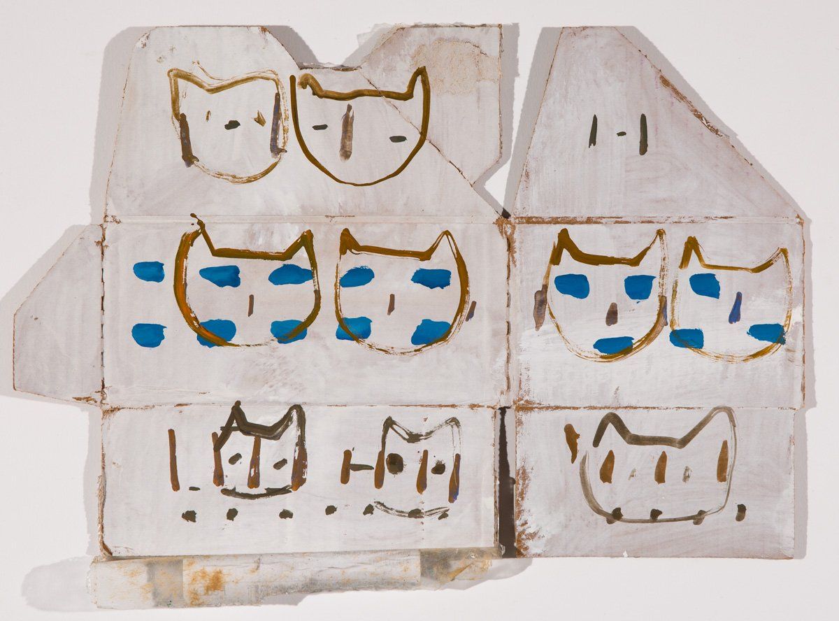 A drawing of a house with cats painted on it