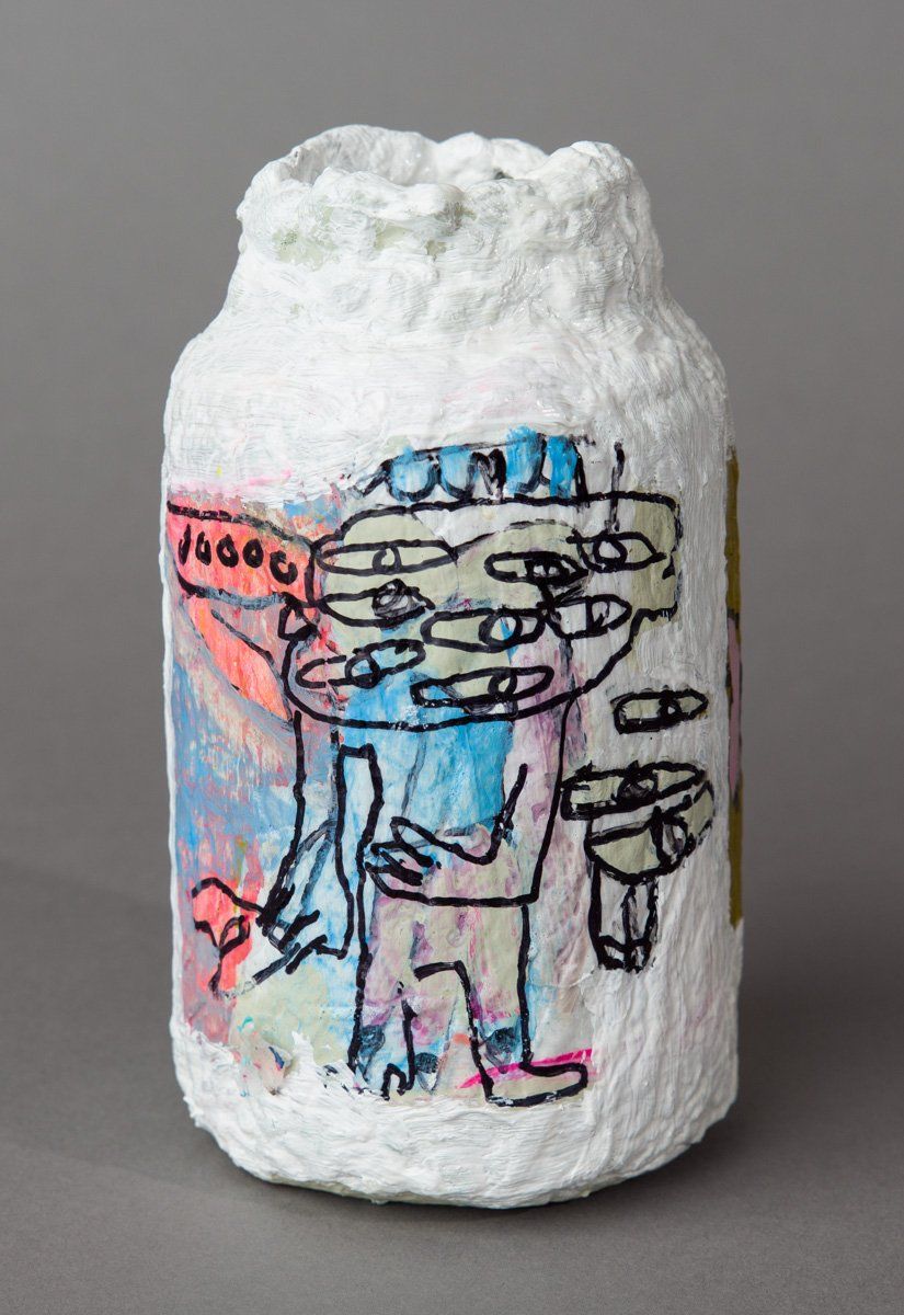 A white jar with a drawing of a man on it.