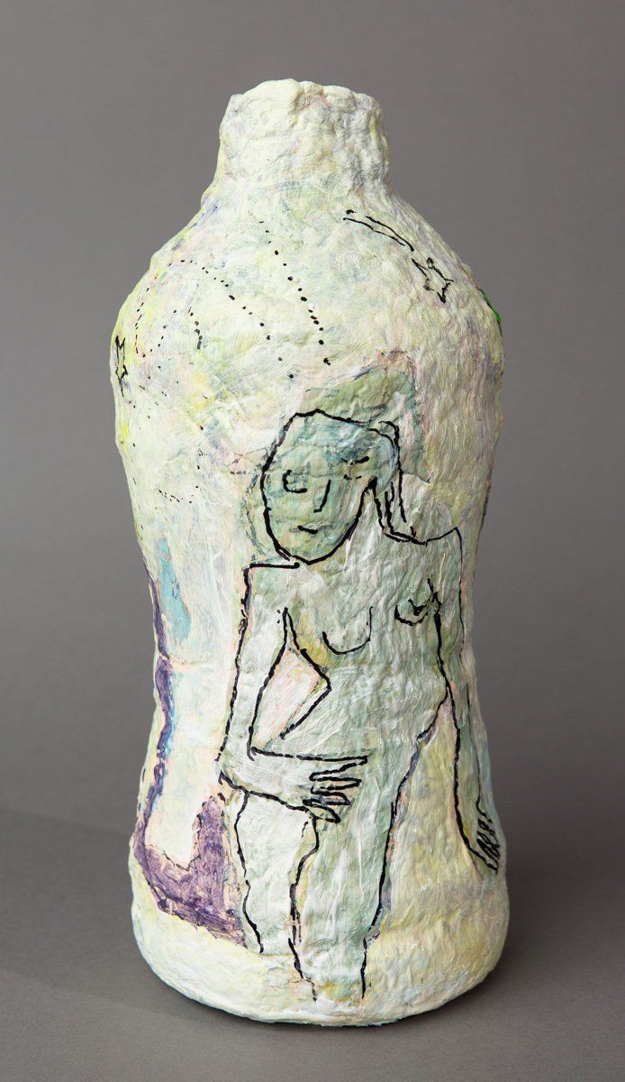A bottle with a drawing of a woman on it.