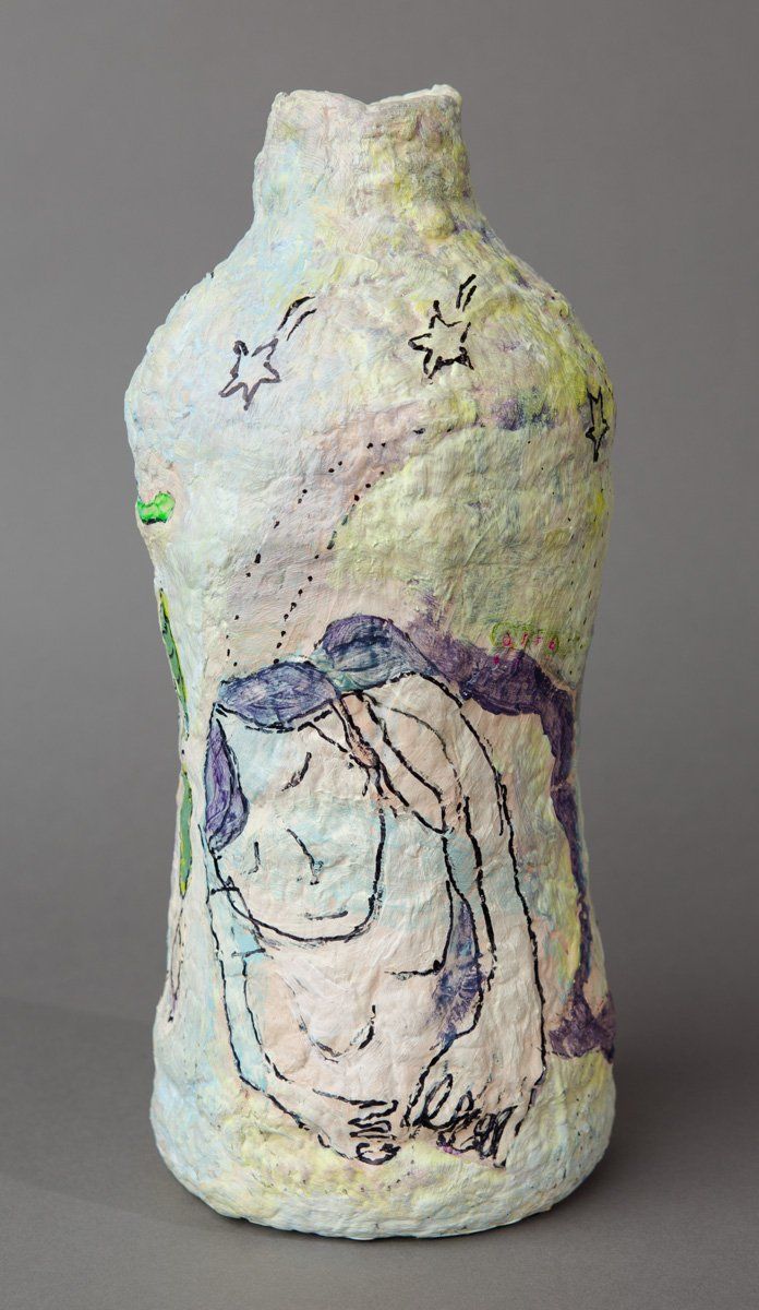 A bottle with a drawing of a cat on it.