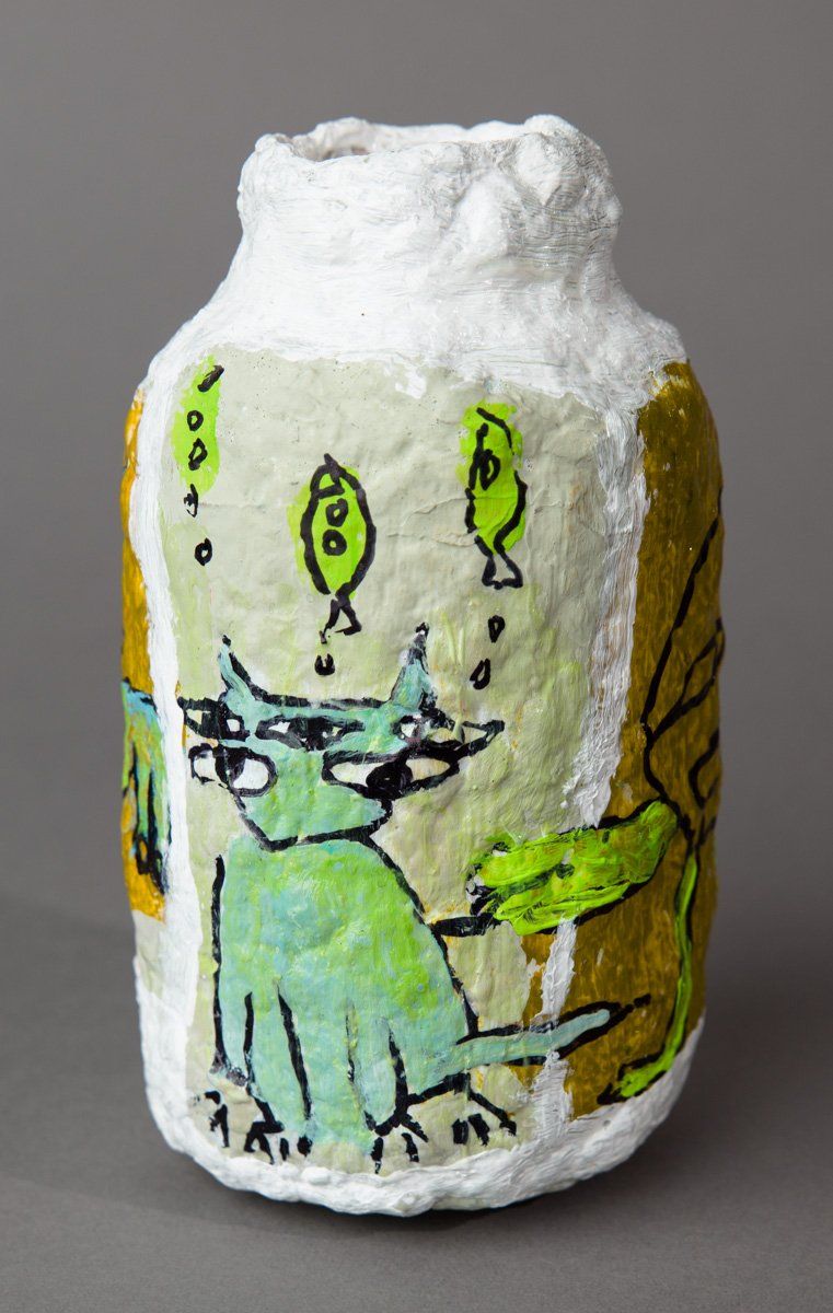 A vase with a drawing of a cat on it.