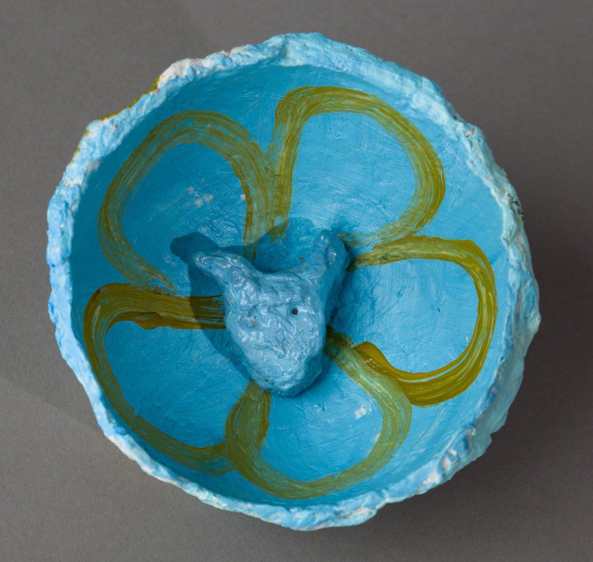 A blue bowl with a yellow flower design on it