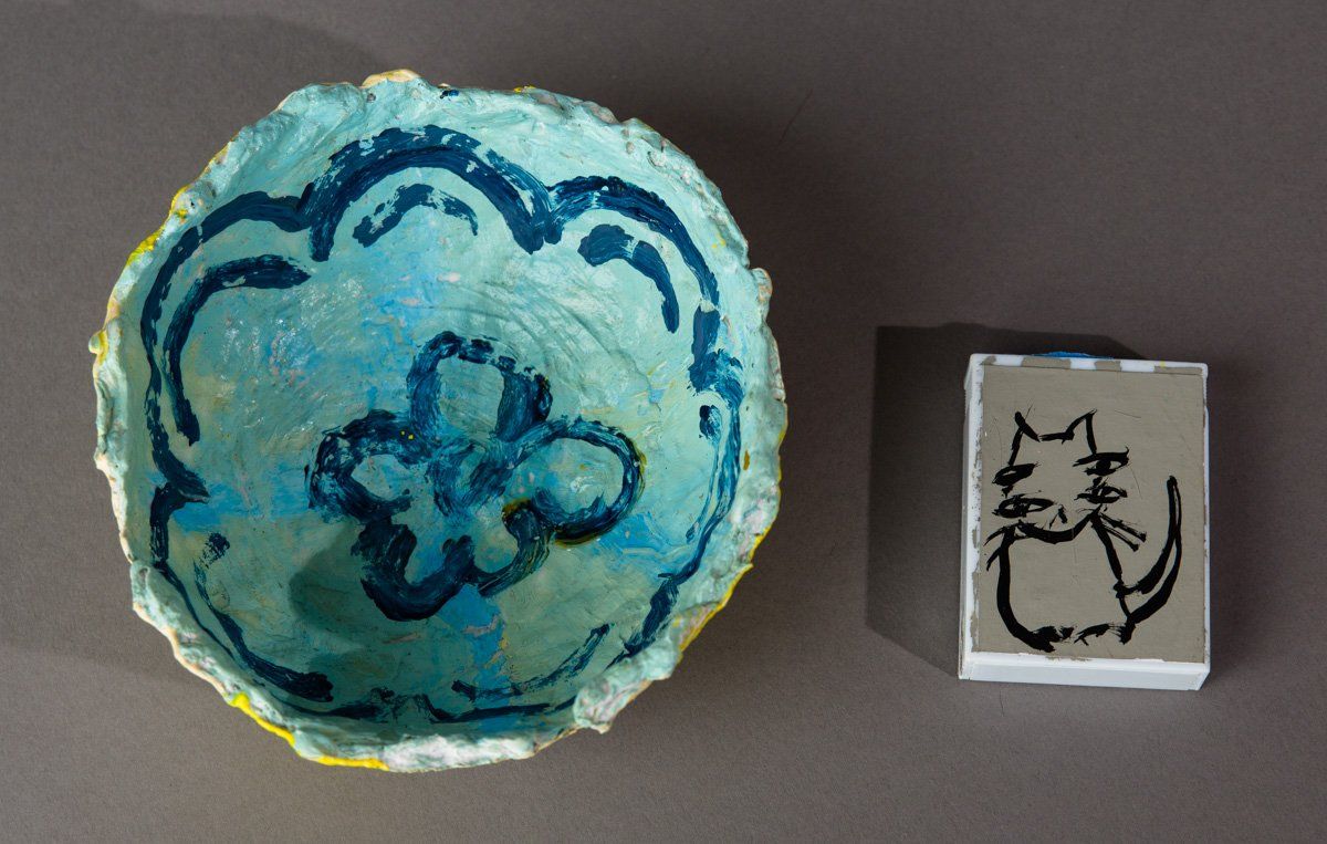 A bowl and a stamp with a cat on it