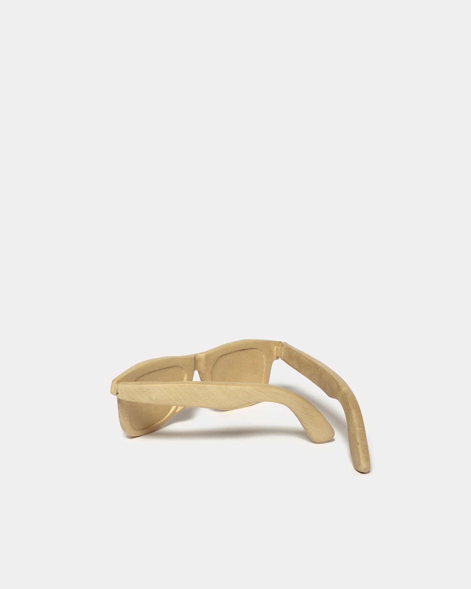 A pair of sunglasses made of wood on a white background.
