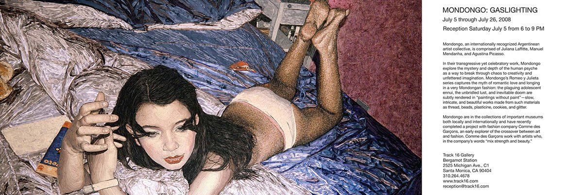 A woman is laying on her stomach on a bed next to a piece of paper.