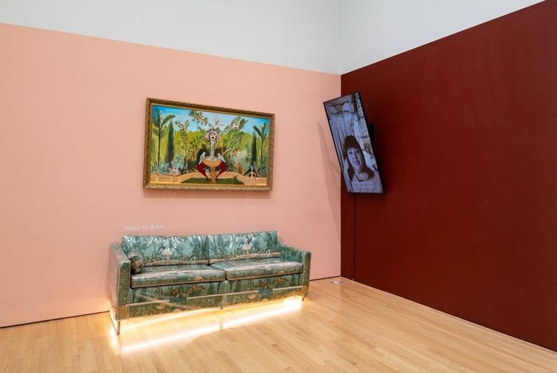 a couch, a painting, and a video monitor