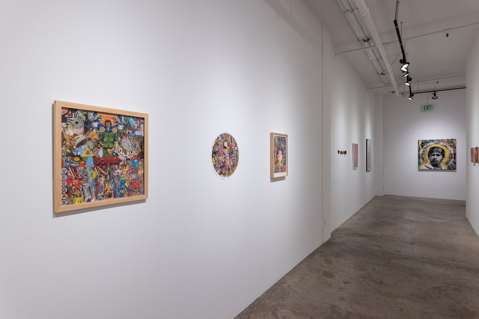 A long hallway with a lot of paintings on the wall.
