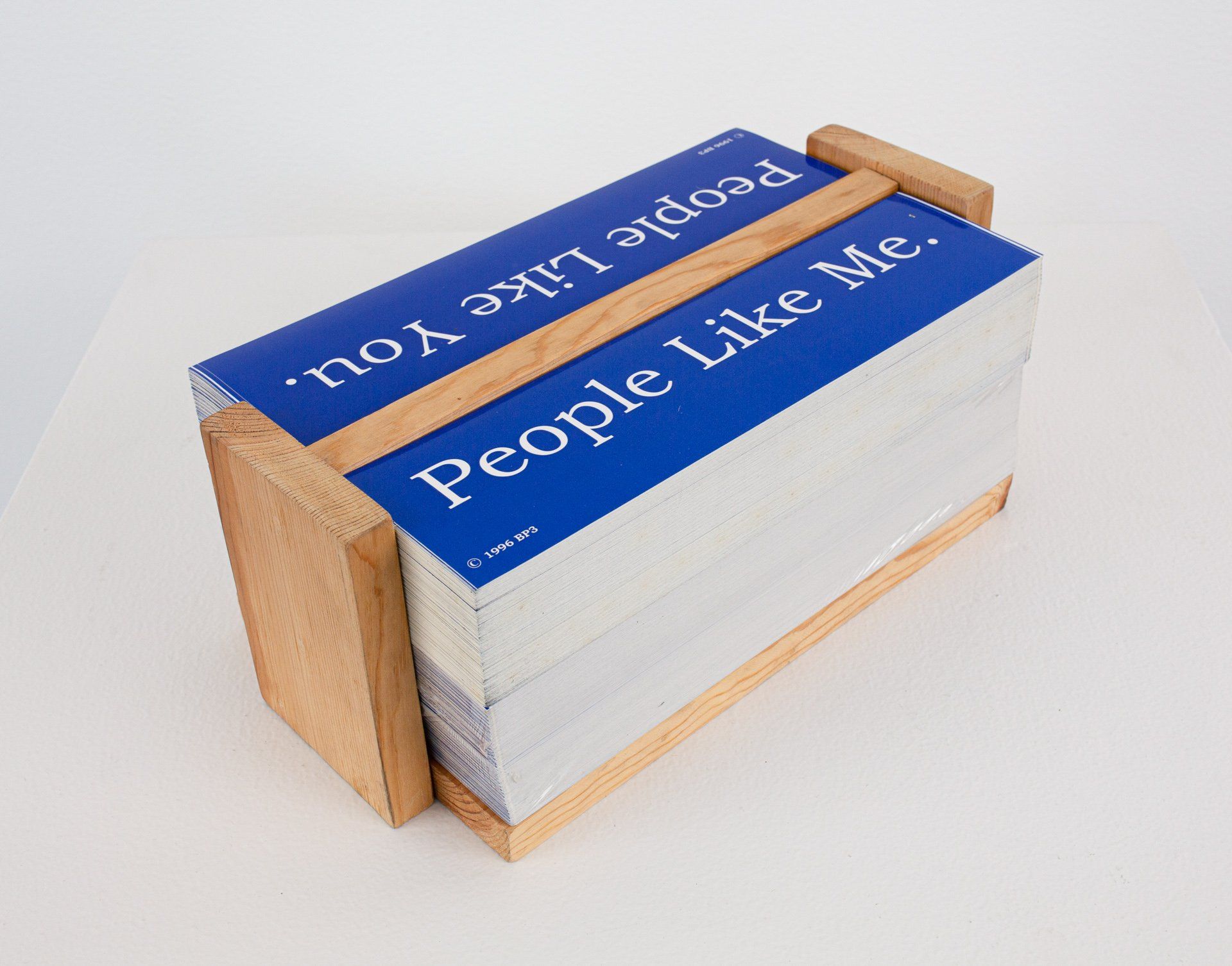 A wooden box with a stack of cards that say people like me