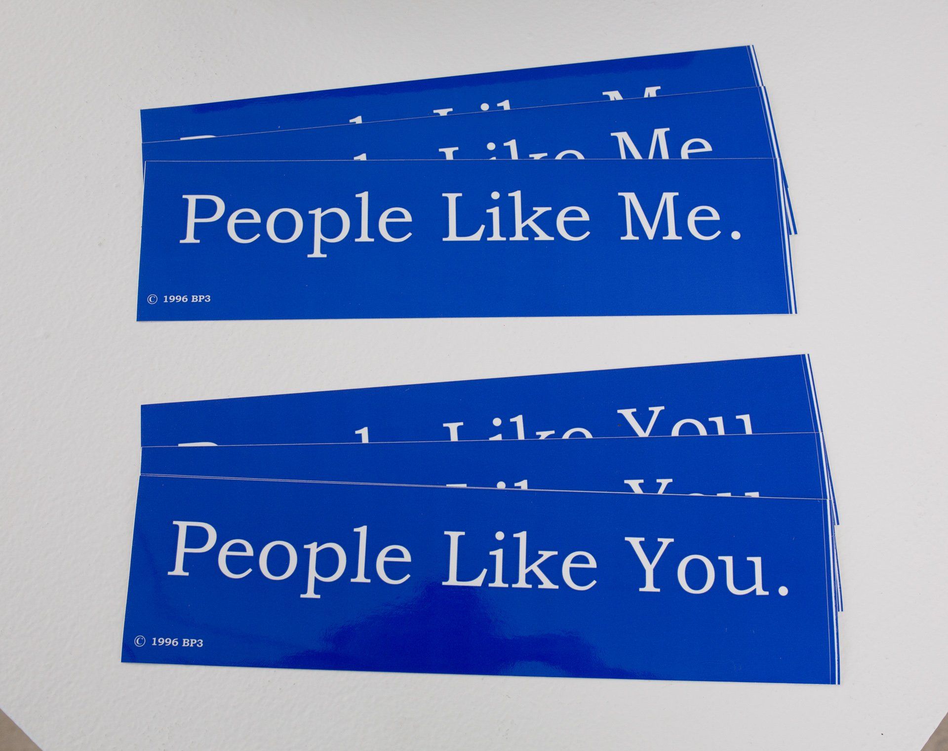 Two blue signs that say people like me and people like you